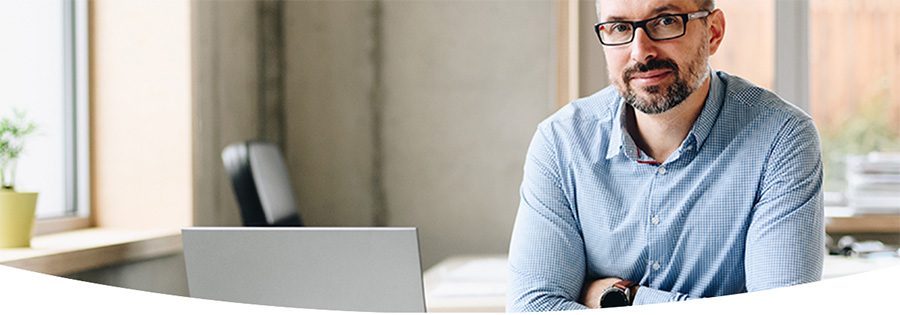 Man with glasses sitting in an office