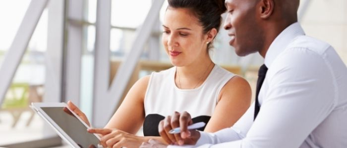 Two people looking at tablet