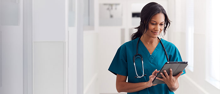 woman medical professional holding tablet