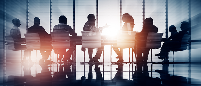 Meeting room with people in chairs