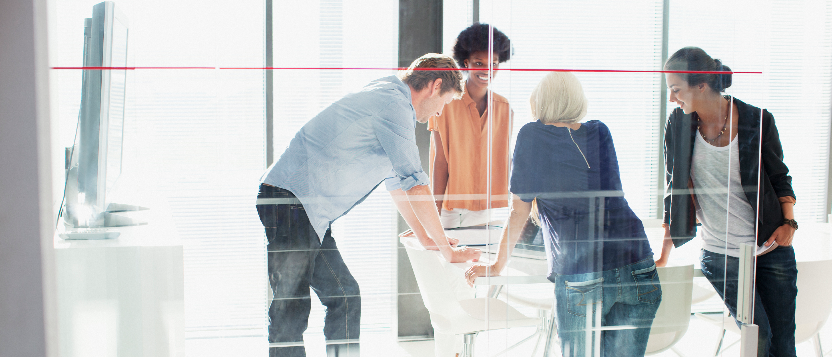 People standing around conference table