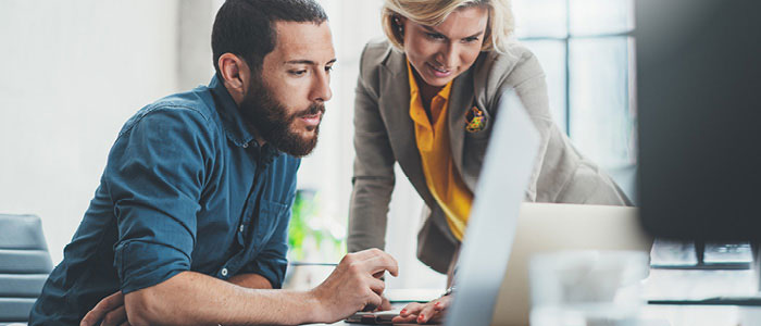 Man and women looking at computer screen