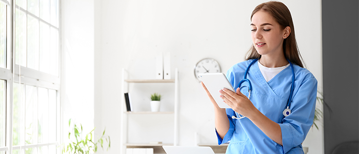 Nurse in doctors office with tablet